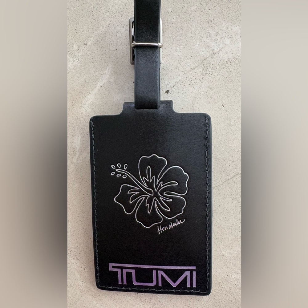 Leather TUMI luggage tag, embossed with Honolulu flower